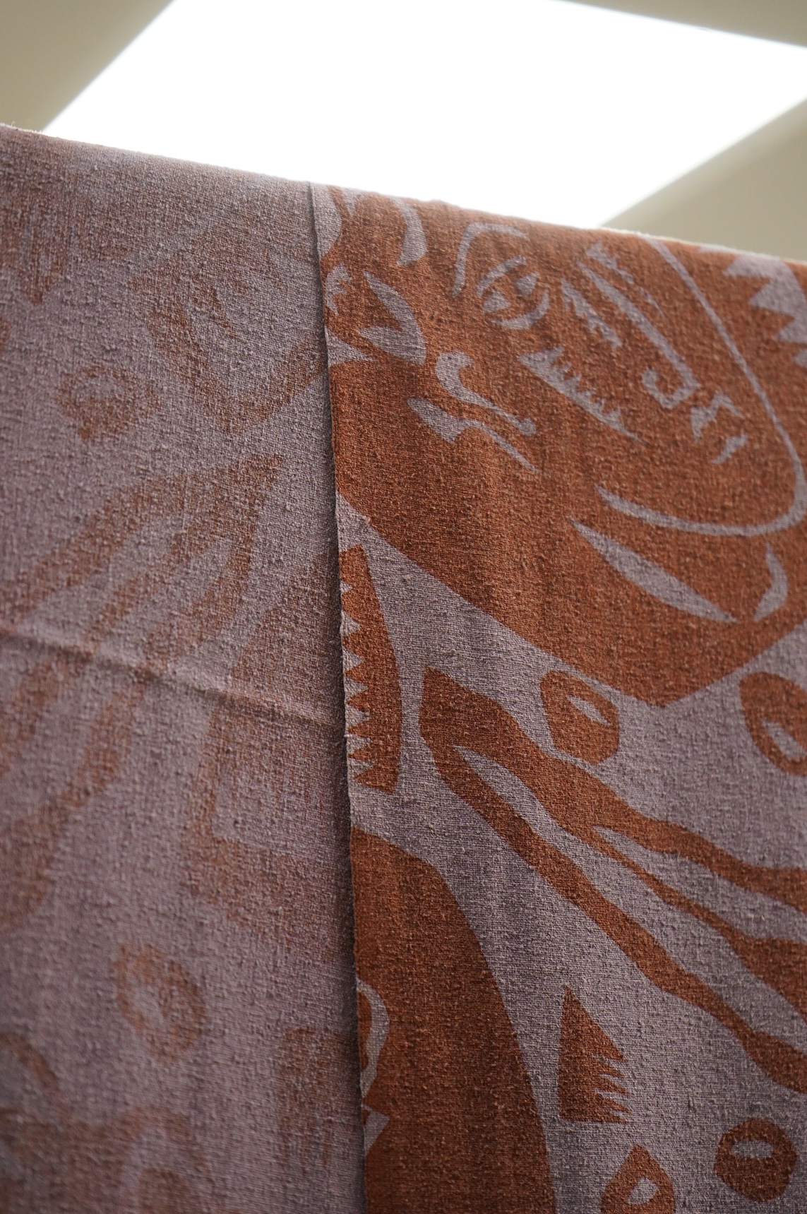 A 1983 A brown mauve paper cut hand printed length of raw silk, designed by Paul Waring, (ex RCA 1983 Syds). 92cm wide x 480cm long. Condition- good, may need dry cleaning.